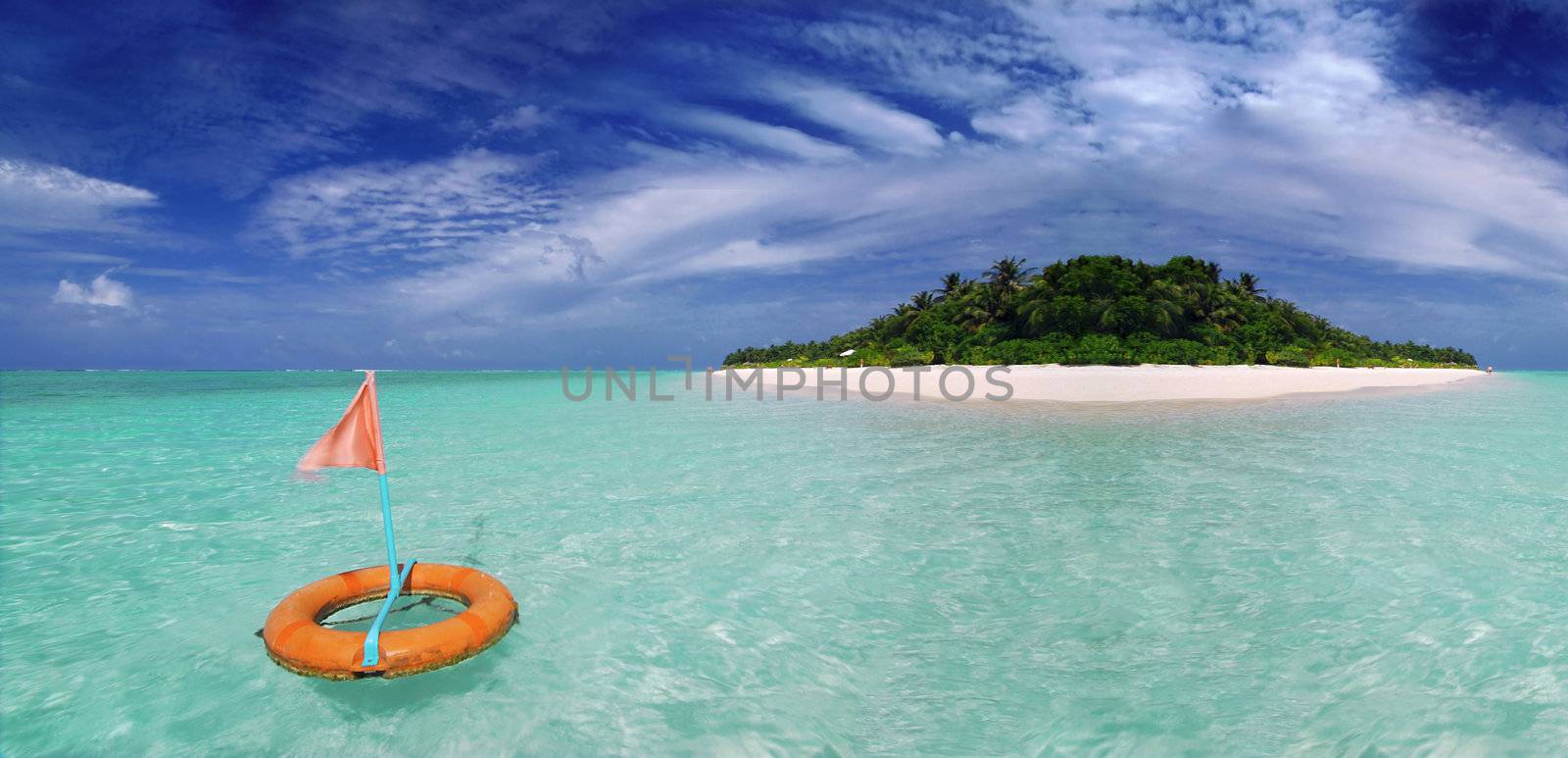 Beautiful Maldivian beach with life buoy in the crystal clear sea