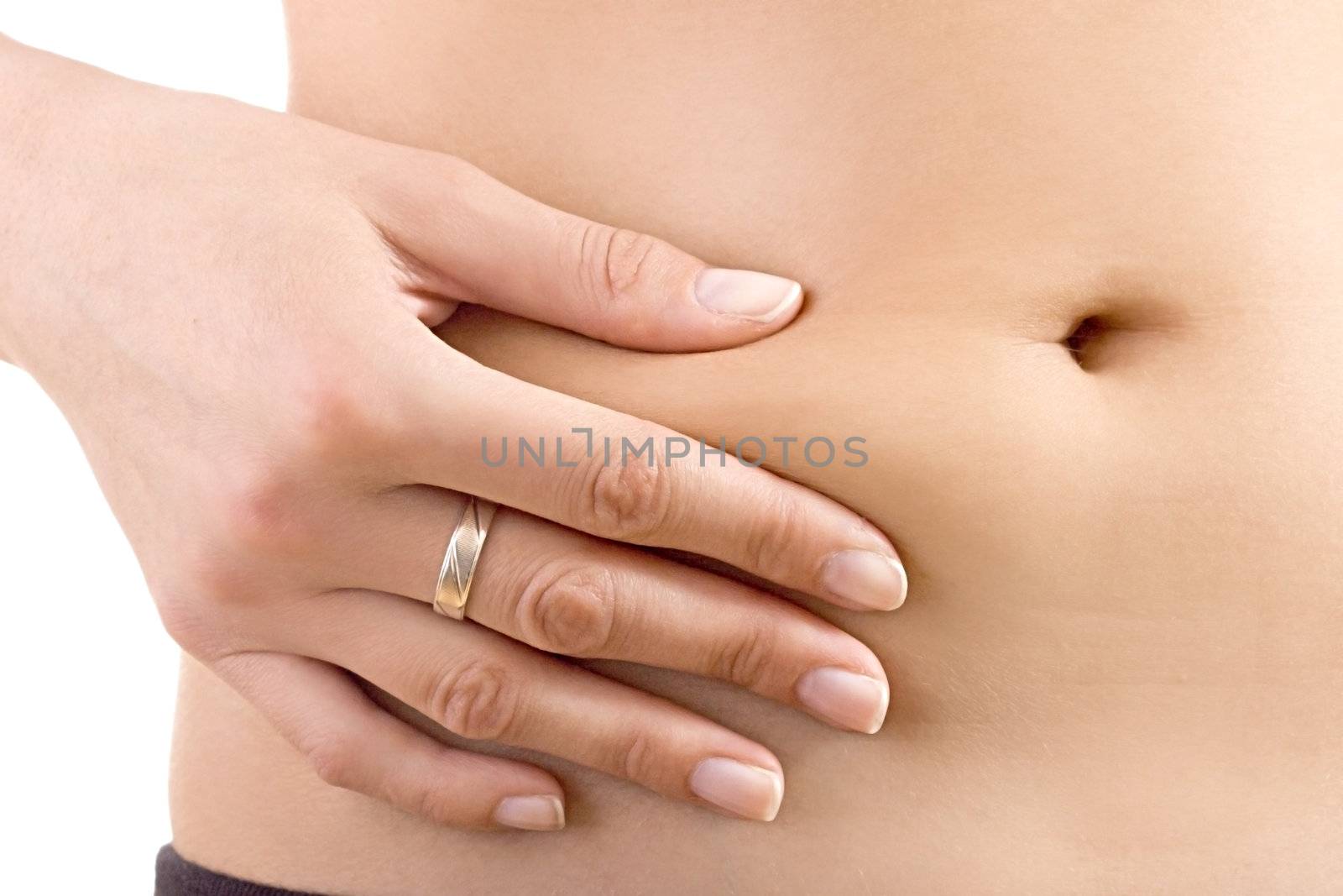 Woman pinches her fat around the bellybutton. 