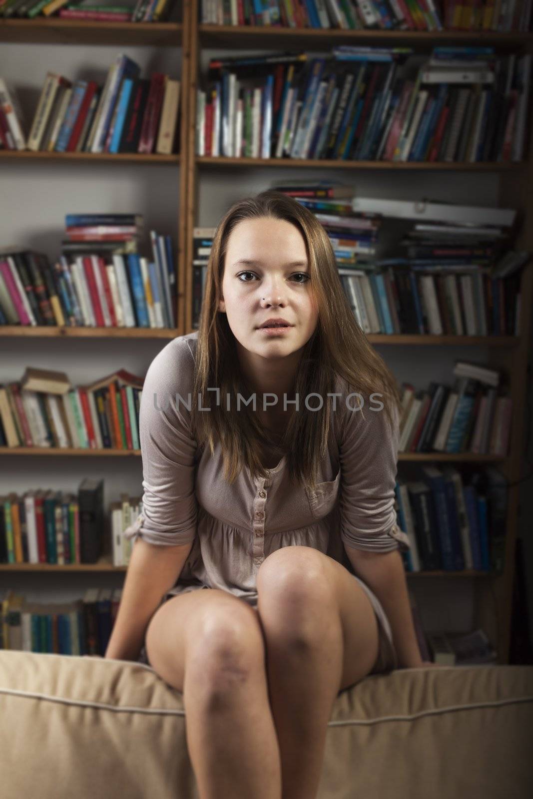 young woman sitting on the couch by bernjuer