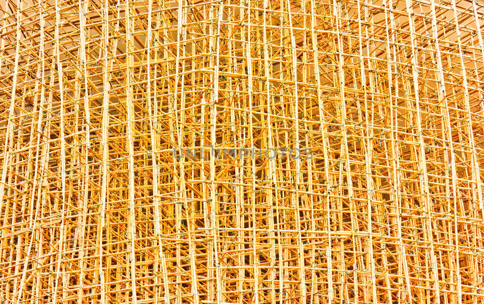 Bamboo scaffolding yellow background.
