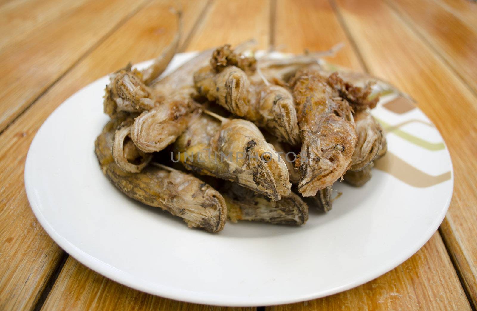 Fried fish on white dish and wood background, delicious thai food