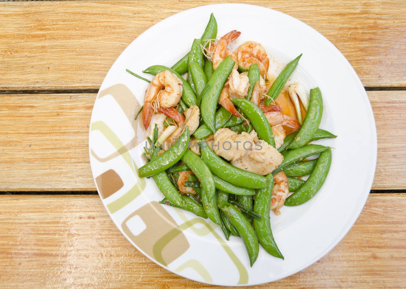 Thai-food Fried shrimp, pork and sweet peas. wood background.