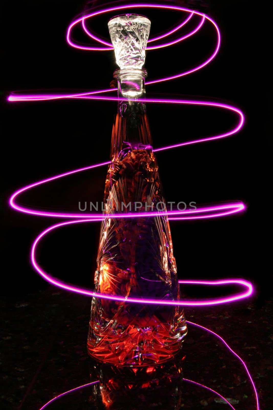 Crystal Bottle Lit Up with Purple Light Trails