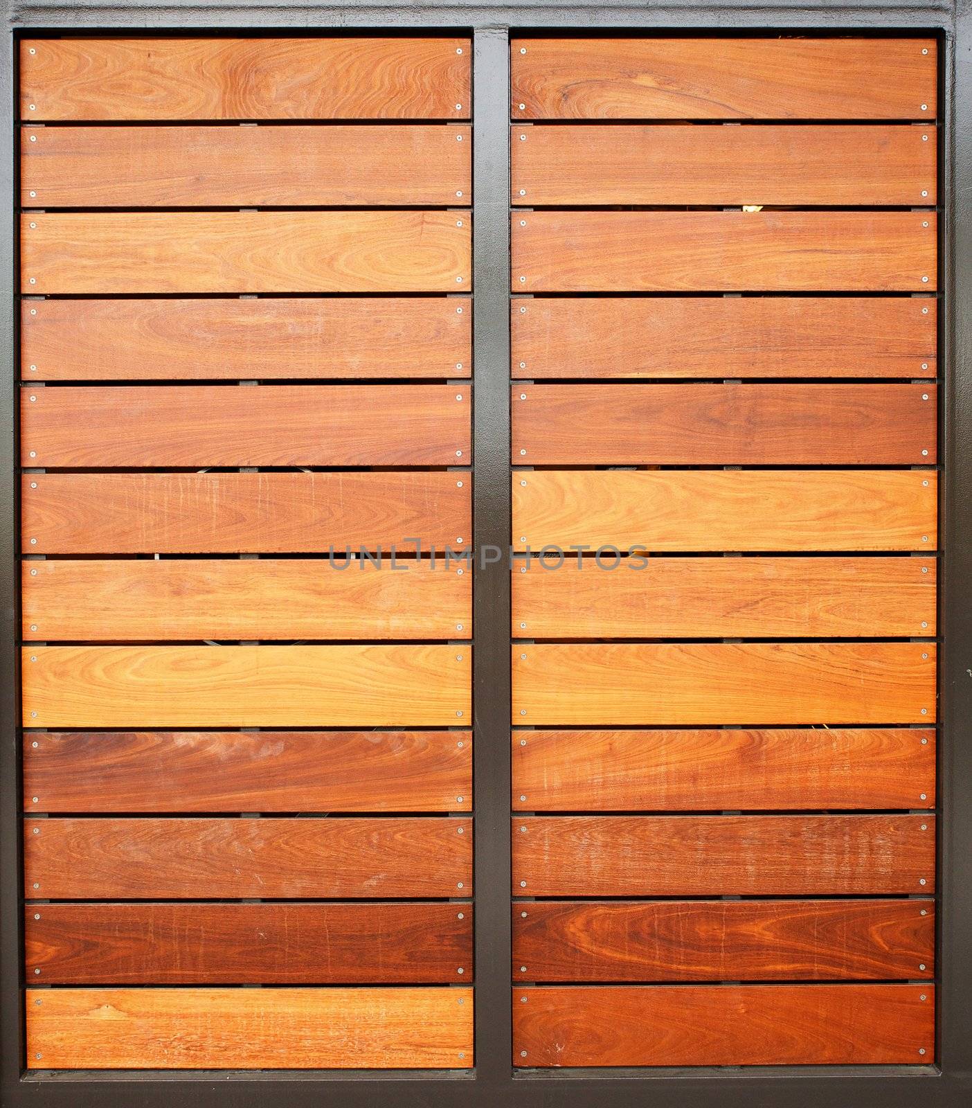 Stained wood framed in steel garage doors vertical