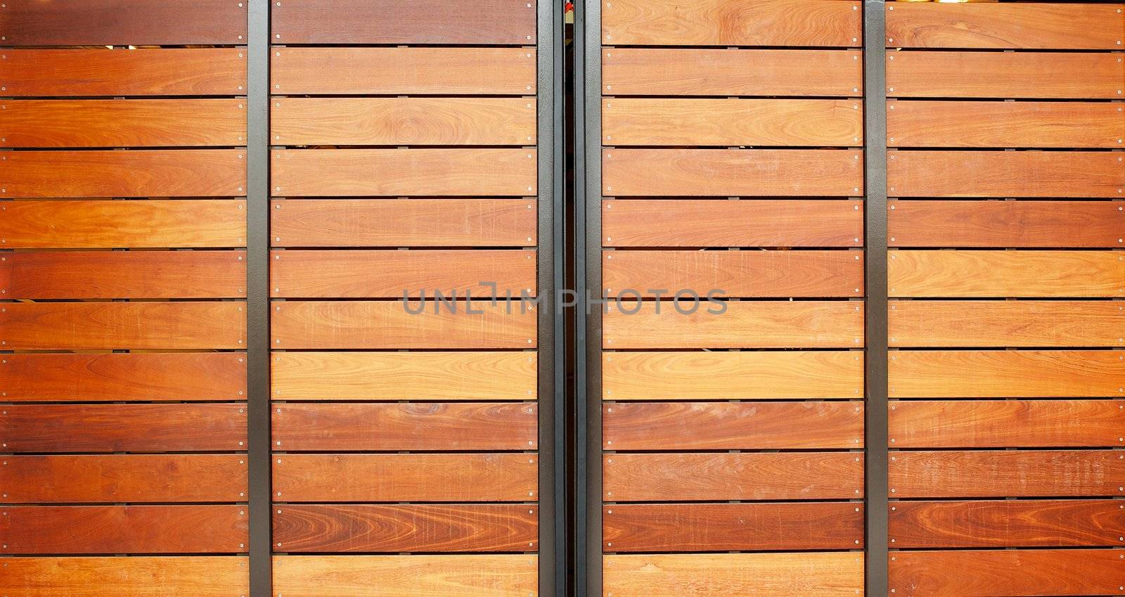 Stained wood framed in steel garage doors horizontal