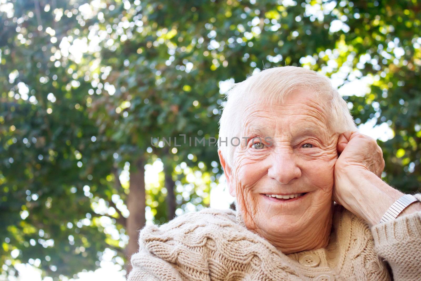 Happy senior lady smiling outside