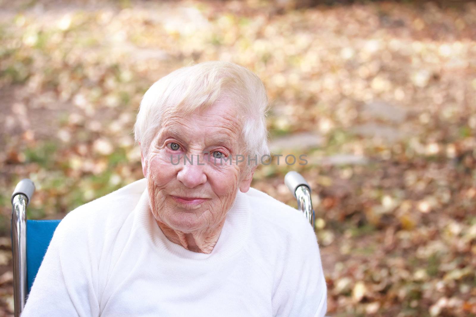 Happy senior lady smiling outside in autumn