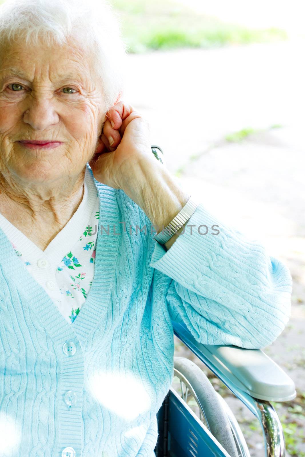 Beautiful senior lady in wheelchair in spring day