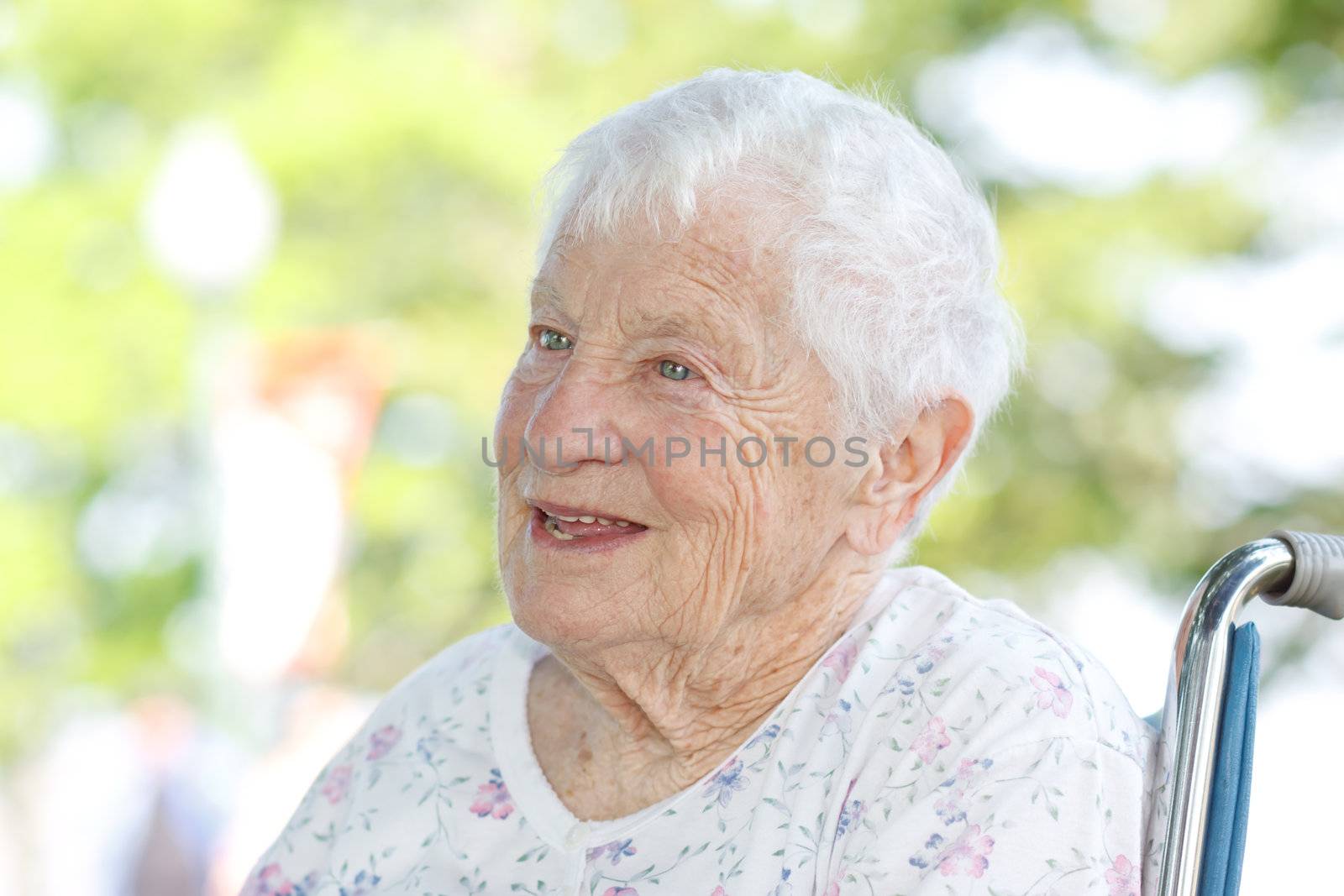 Happy Senior Woman in a Wheelchair Outside