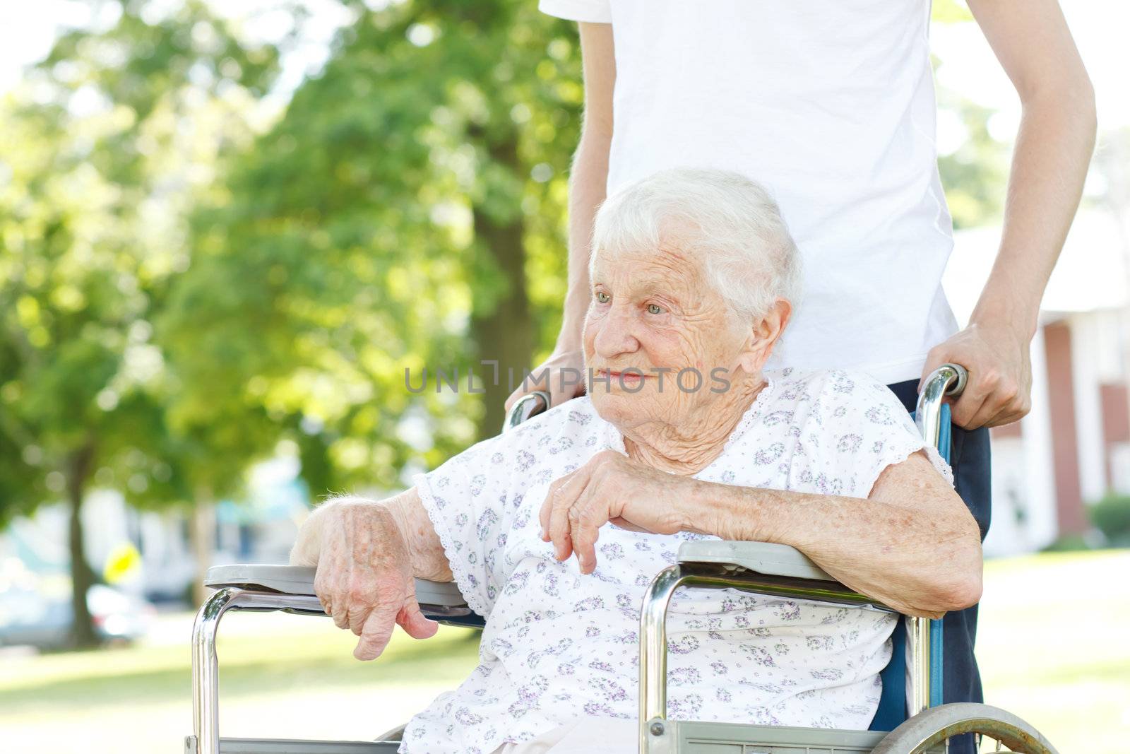 Senior Women in Wheelchair with Caretaker by melpomene