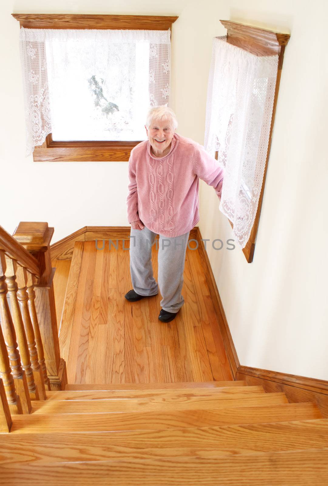 Senior woman in front of staircase in day time