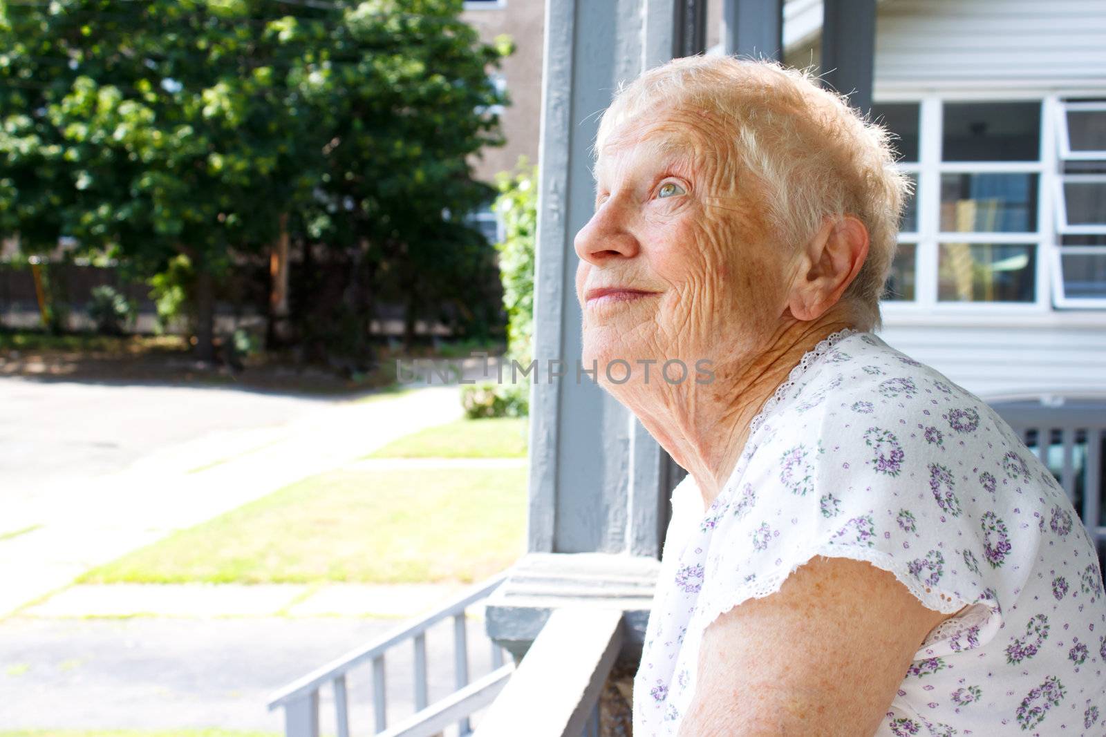 Happy senior lady relaxing in porch