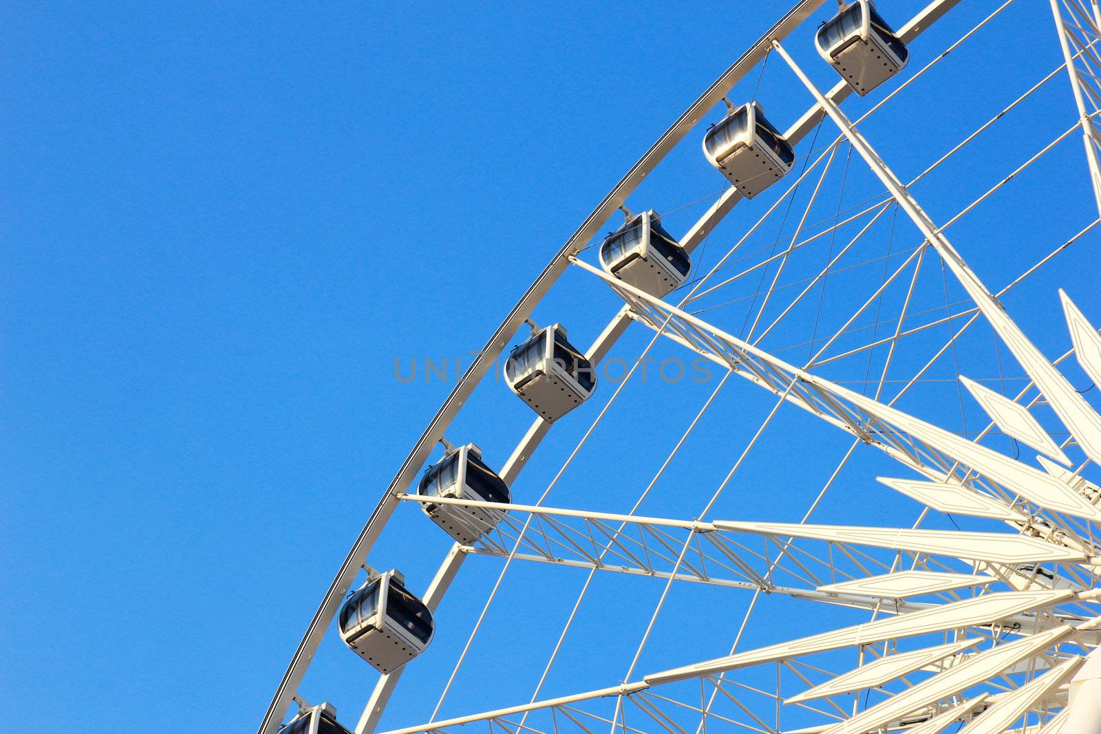 Close up of ferris wheel with clear blue sky by nuchylee