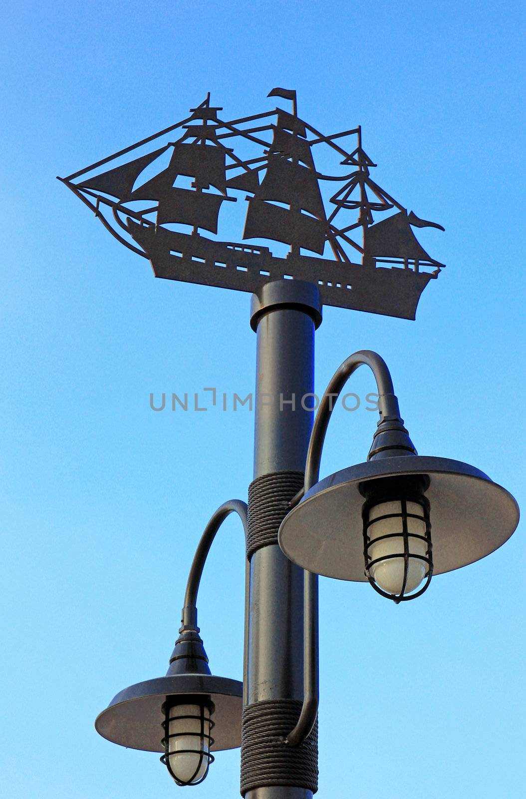 Decorative street lamp-post on blue sky by nuchylee