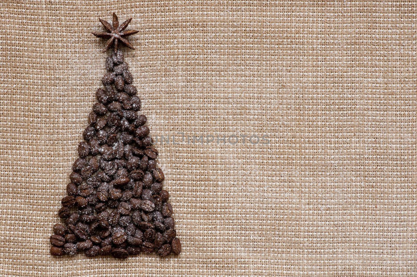 christmass tree made of coffee beans on sack background postcard