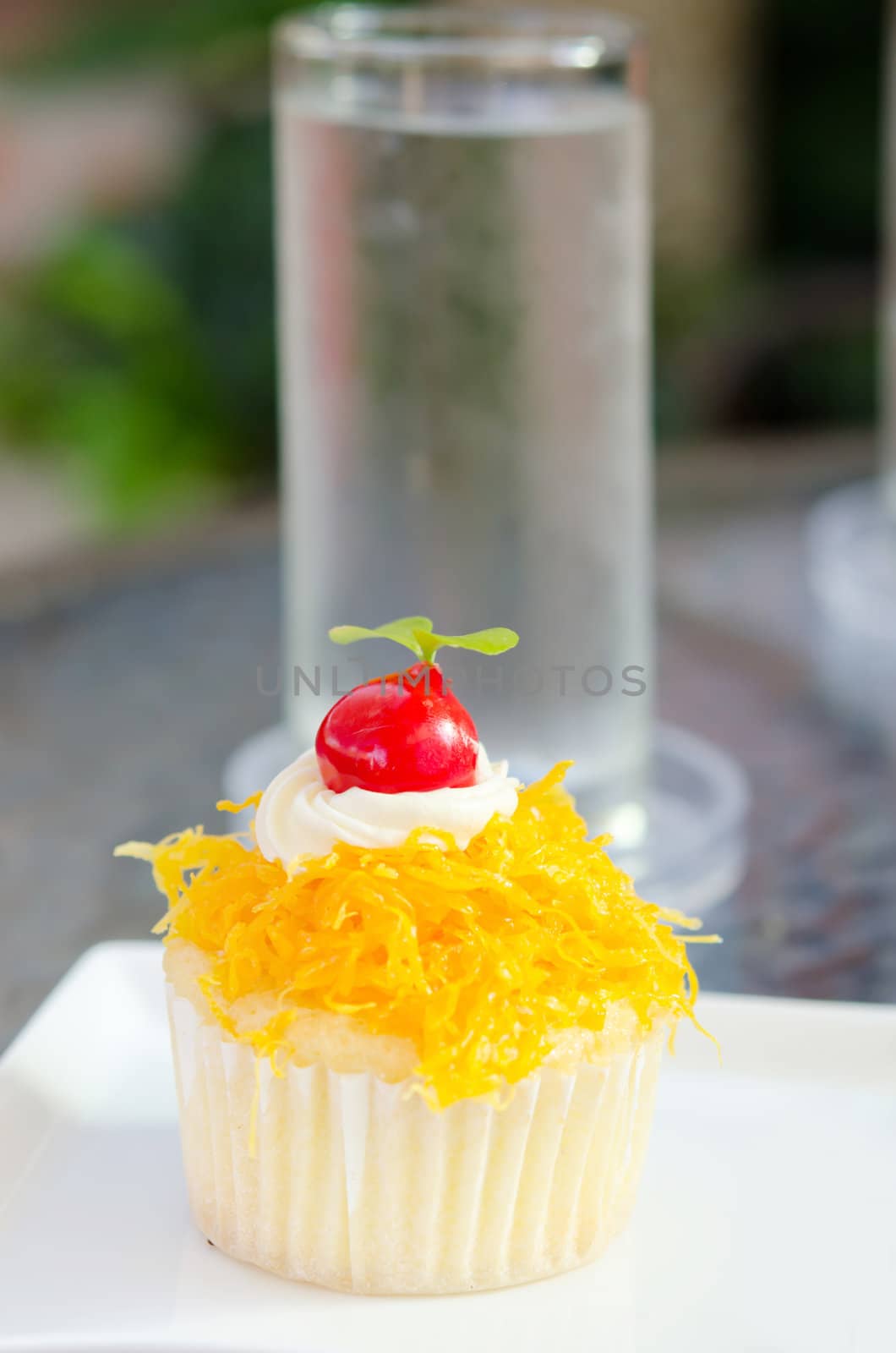  thai sweetmeat or call it " cake foi thong" in front of water glass