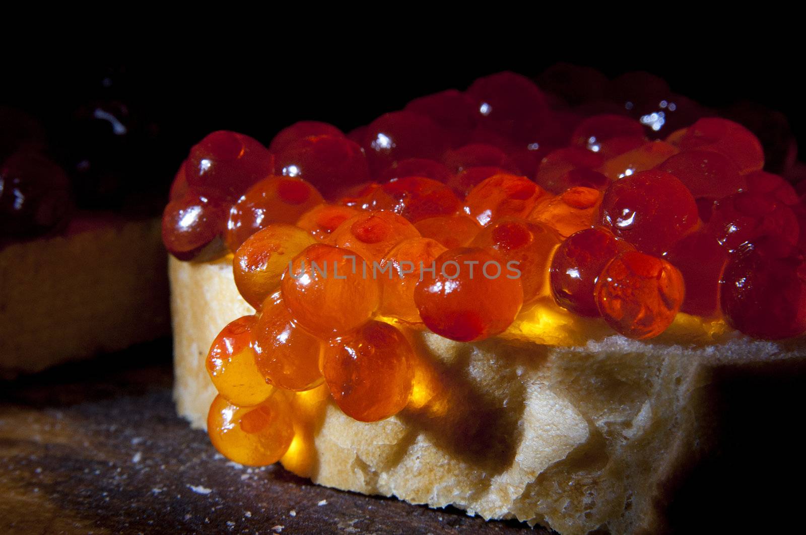 Salmon caviar on fresh baguette