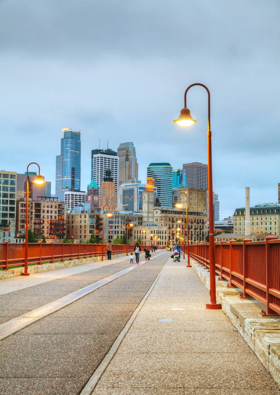 MINNEAPOLIS - May 07: Downtown Minneapolis, MN at night time on May 07, 2012 as seen from Stone Arch bridge. The Stone Arch Bridge is a former railroad bridge crossing the Mississippi River at Saint Anthony Falls in downtown Minneapolis.