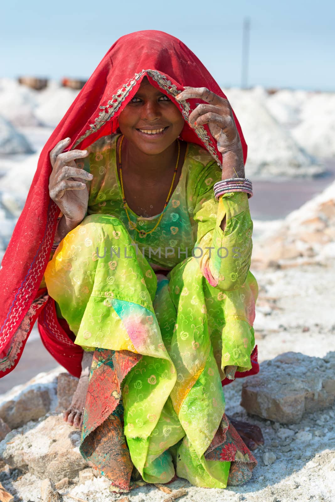 Sambhar, India - Nov 19: Portrait of indian female worker in salt farm on Nov 19, 2012 in Sambhar Salt Lake, India. It is India's largest saline lake and where salt has been farmed for a thousand years. 