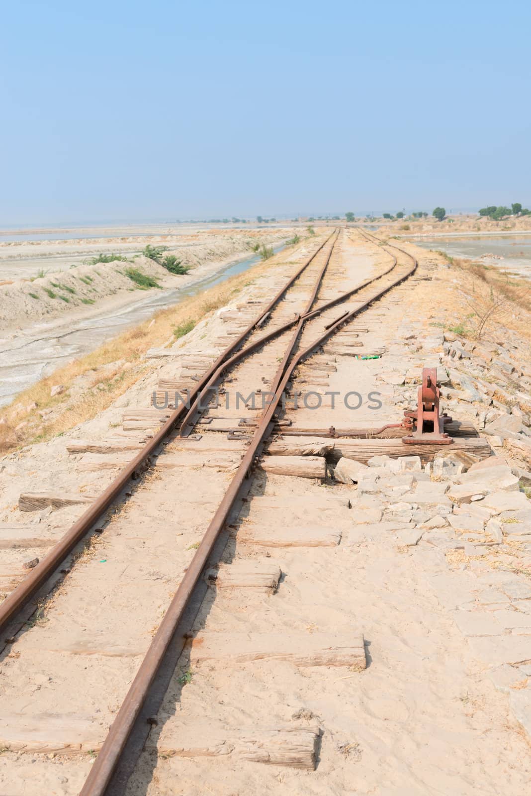 Old railway on Sambhar Salt Lake, India by iryna_rasko