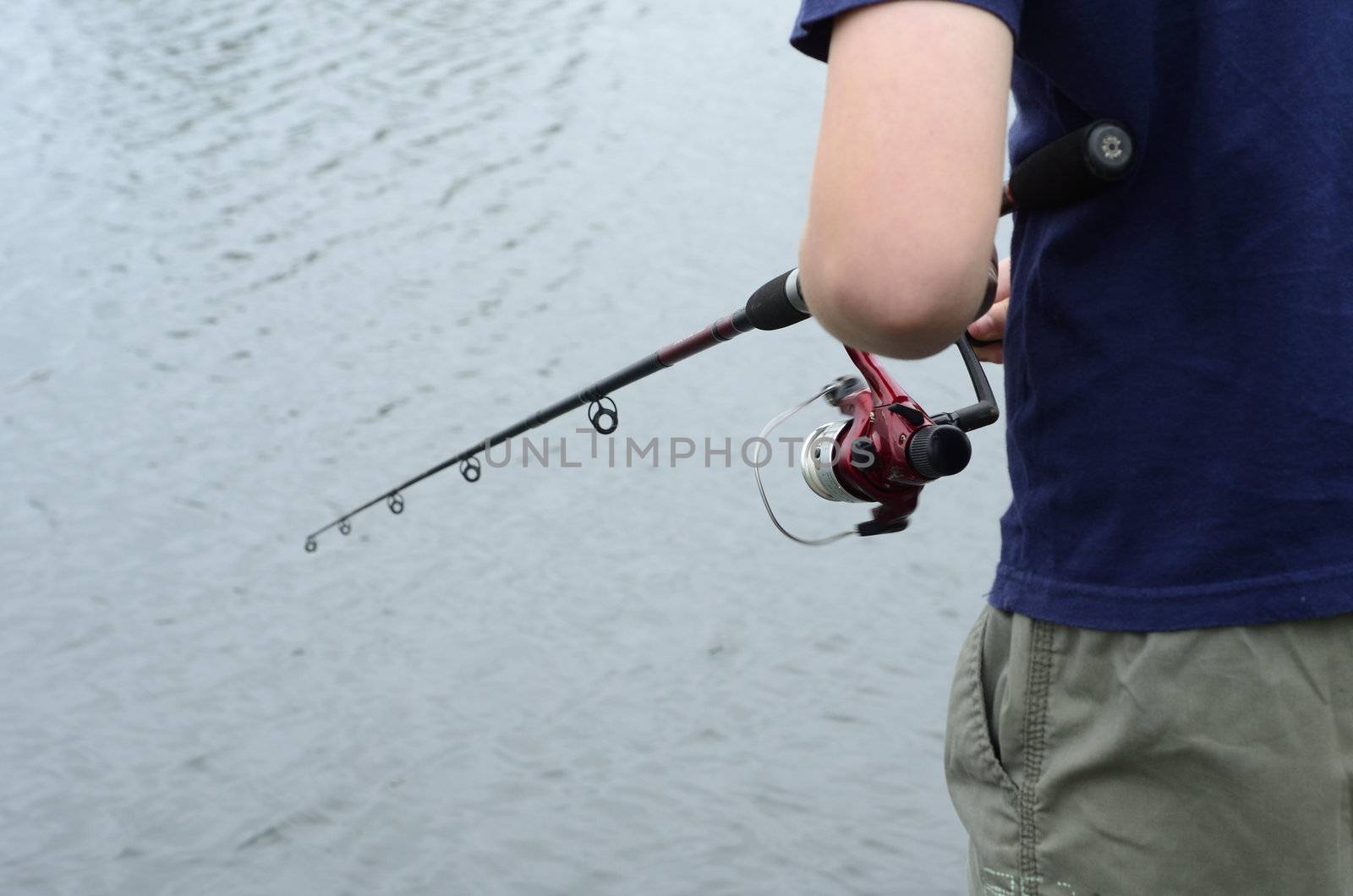 Boy fishing in bass dam or lake