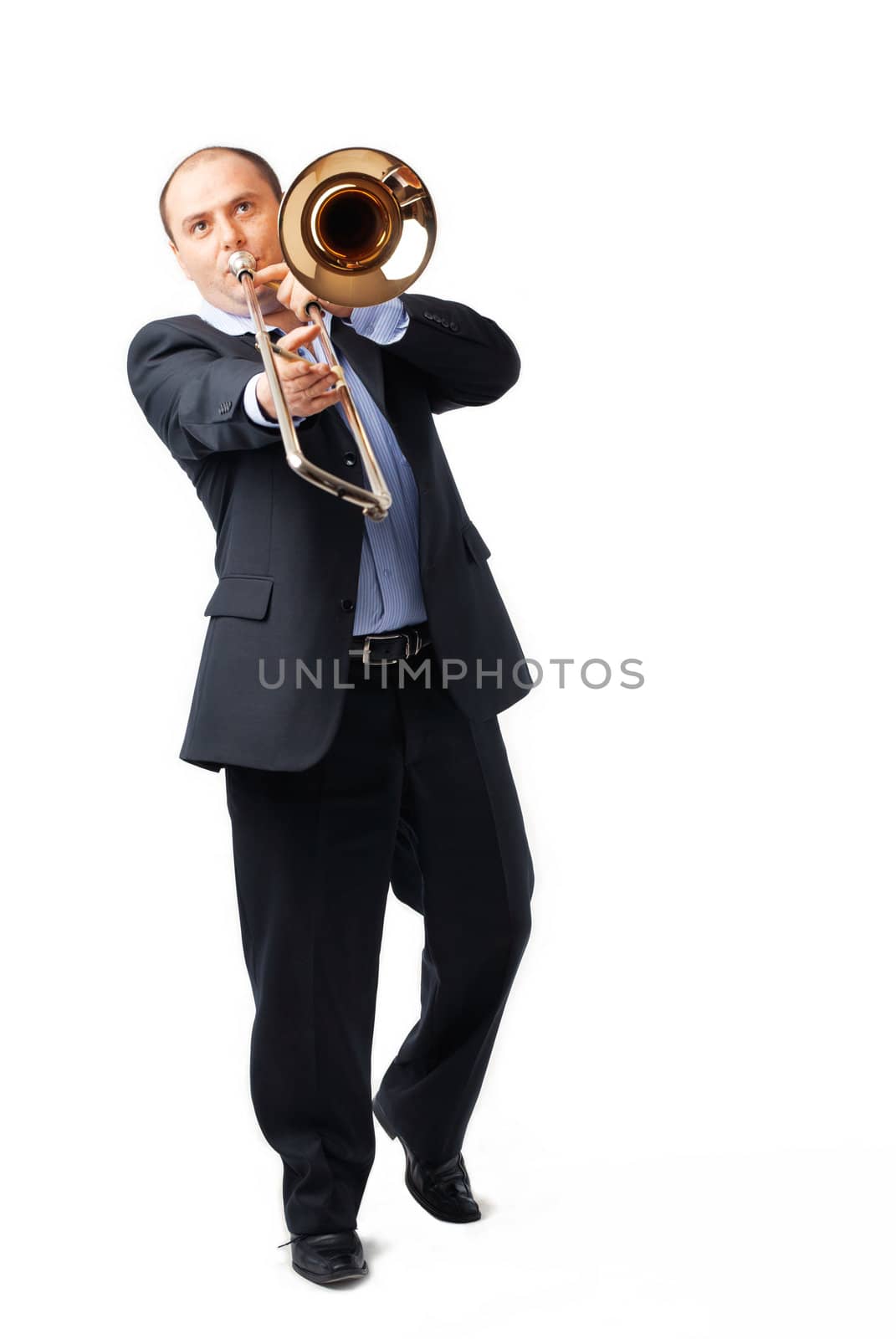 Portrait of a young man playing his trombone on white