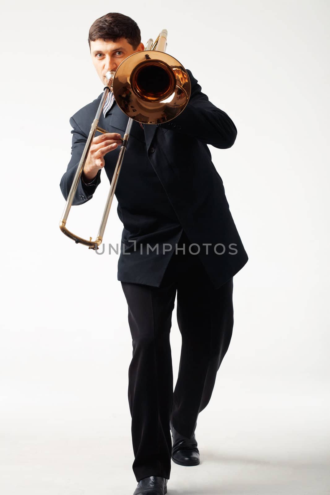 Young man playing his trombone.