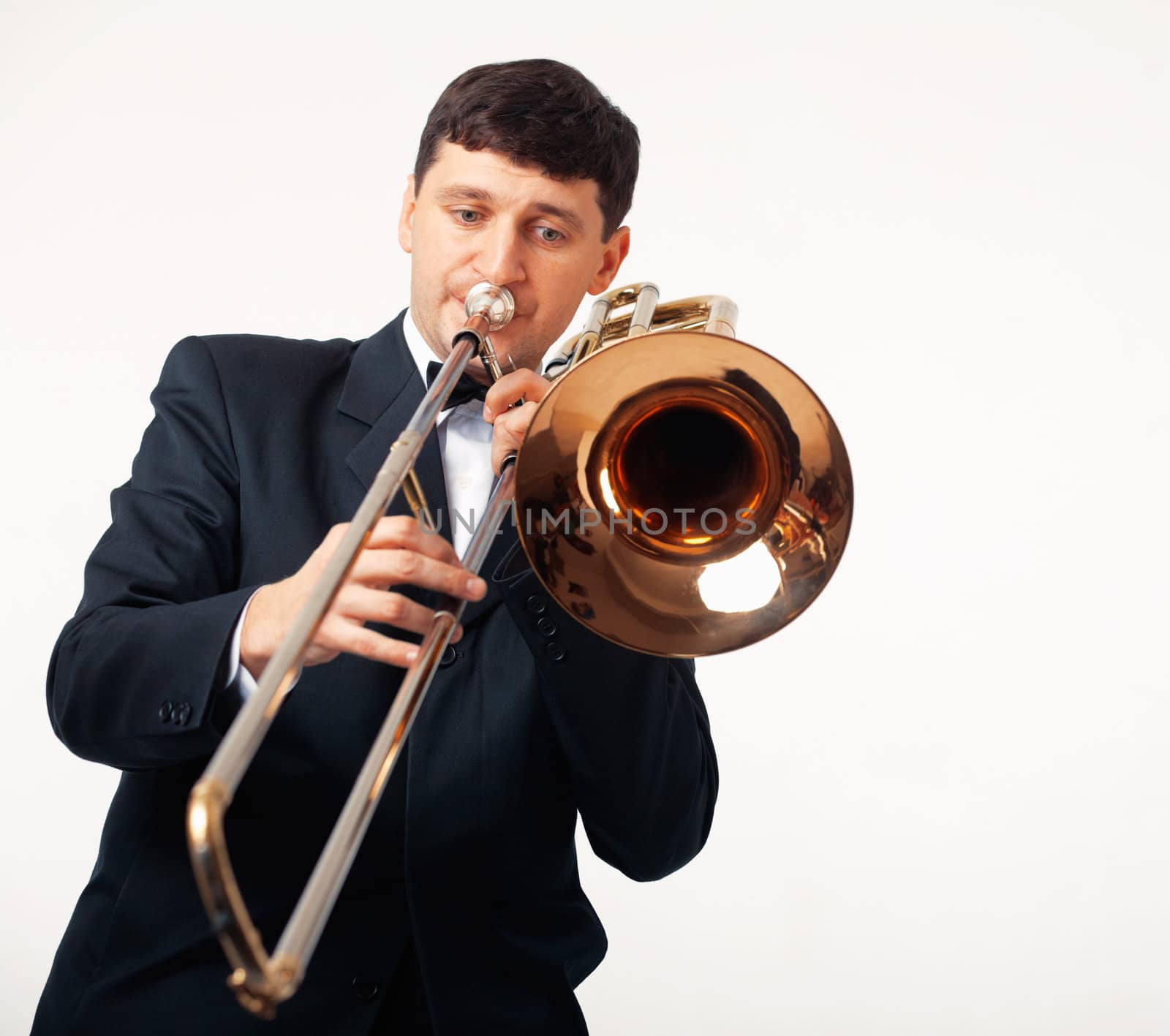 Young man playing his trombone.