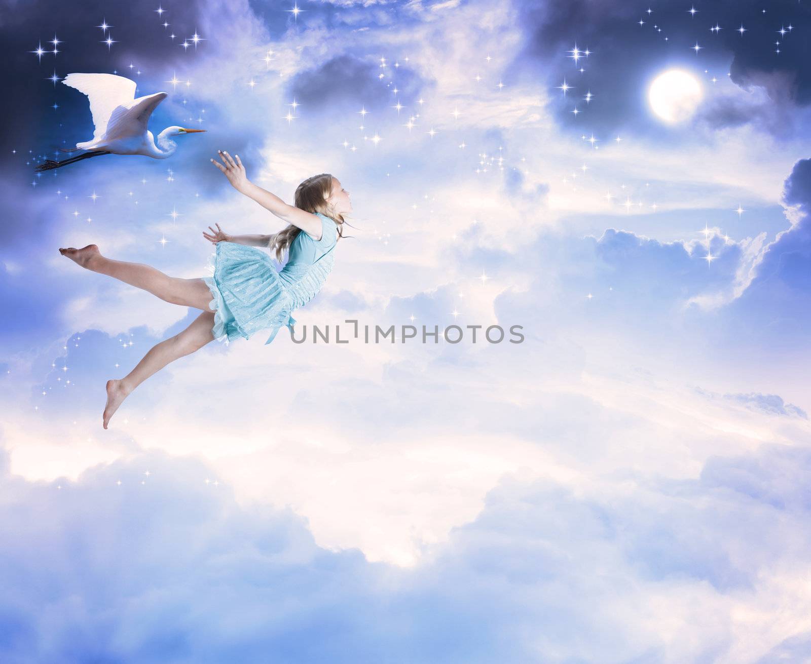 Little girl flying into the blue night sky with white egret