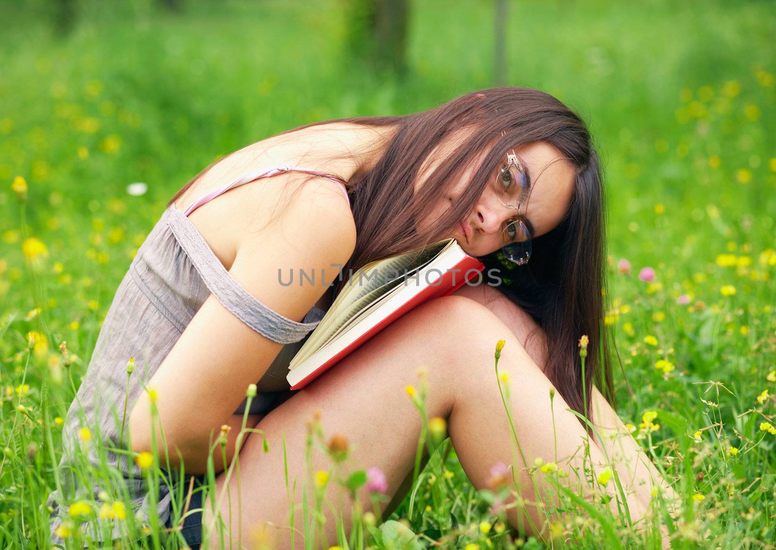 Young  female student holding a book   by romanshyshak