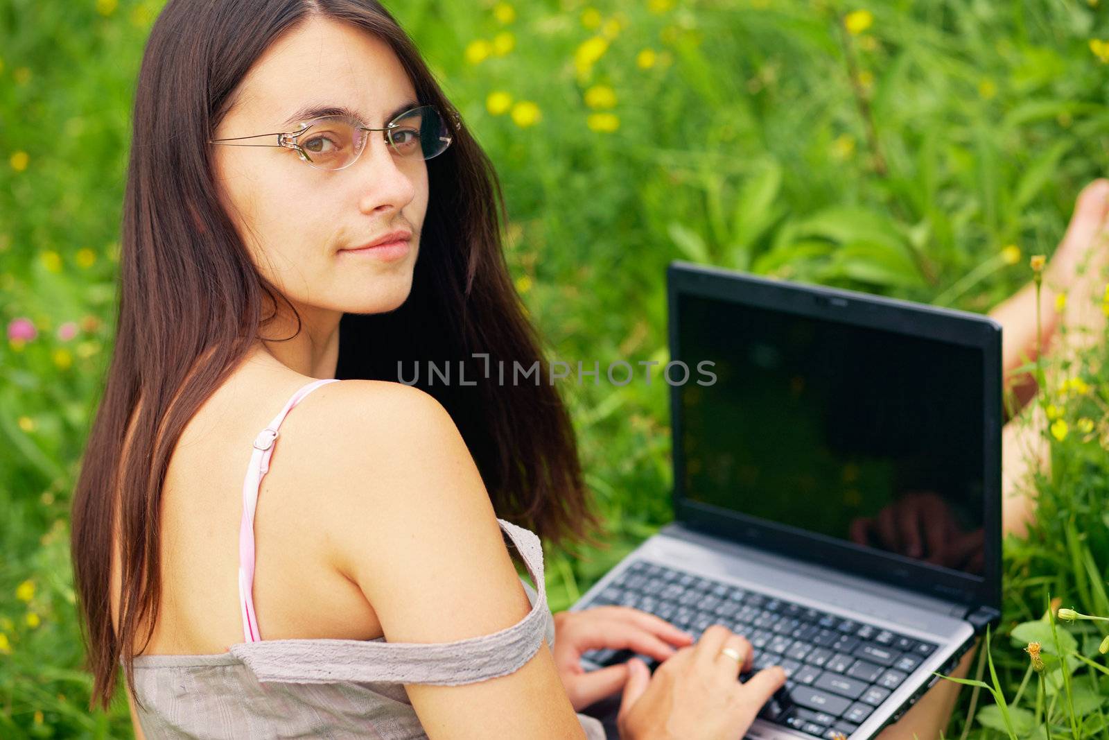 Close-up portrait of a woman with laptop outdoors