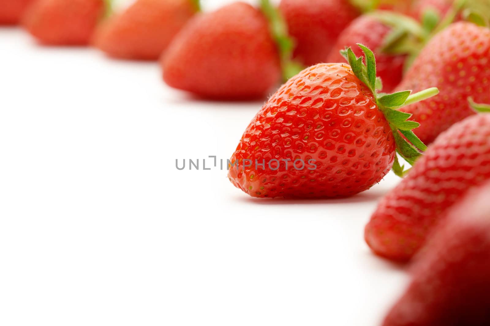 Strawberries with green leaves.This image is focused on one of them