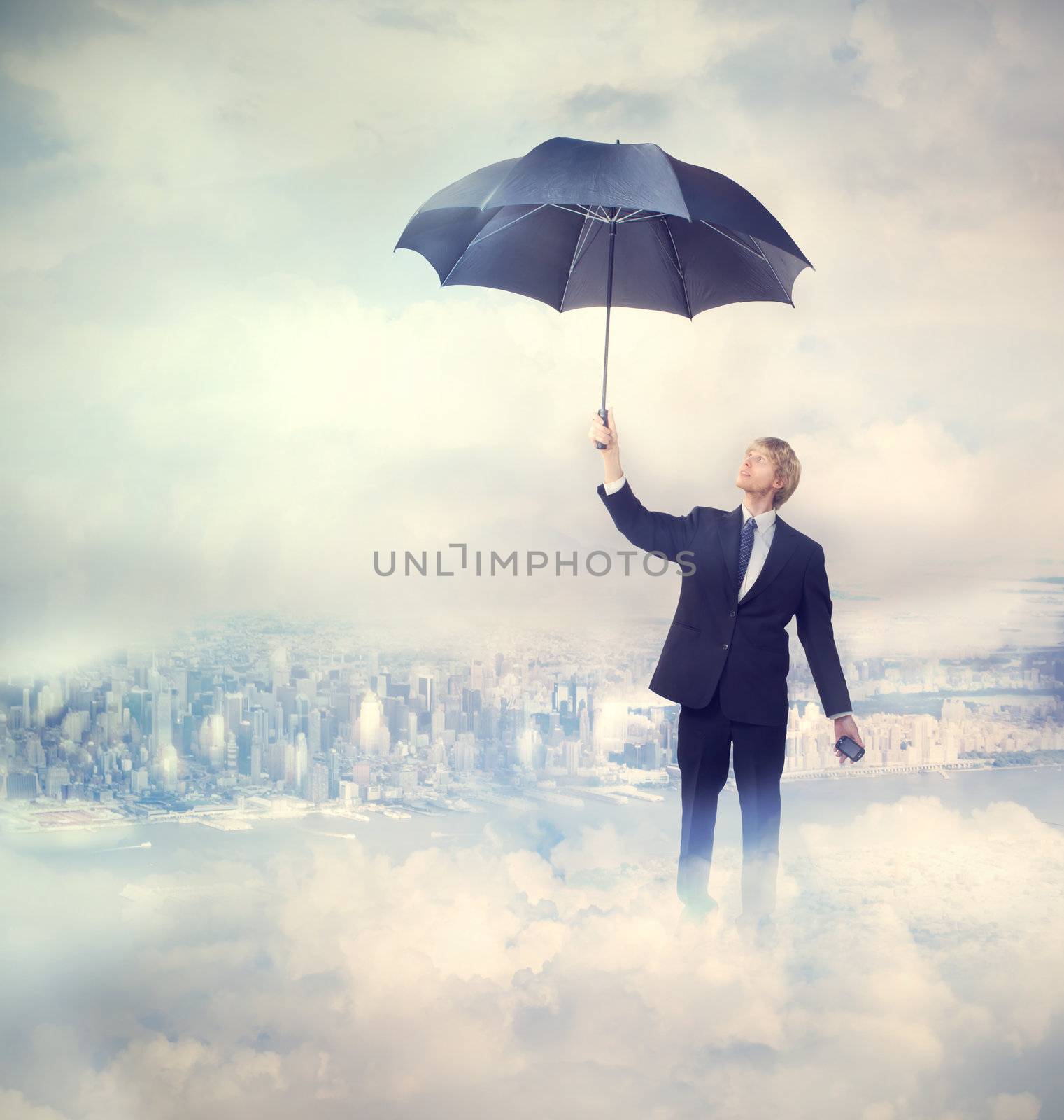 Business man holding an umbrella on the clouds