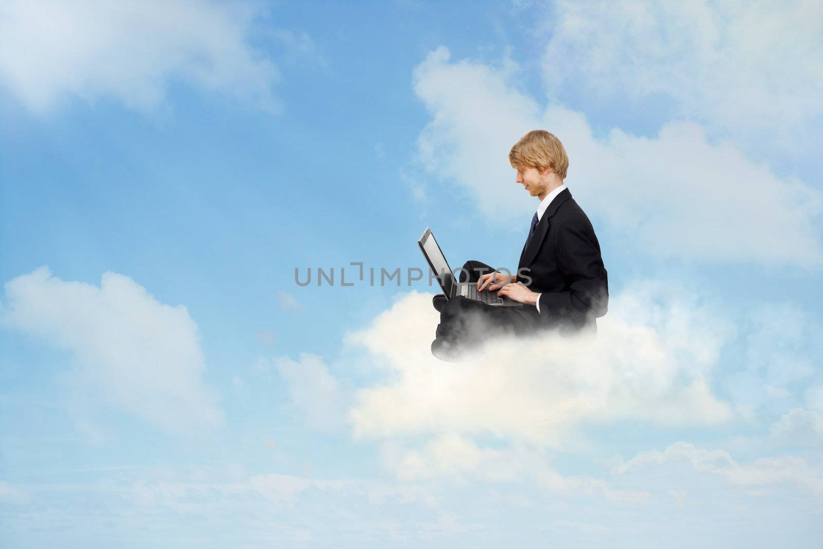 Young business man sitting on clouds and using a laptop 