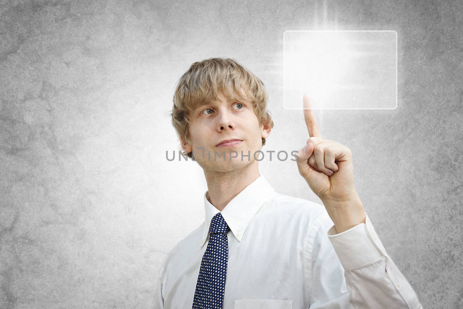 Young business man pressing a button on a touch screen