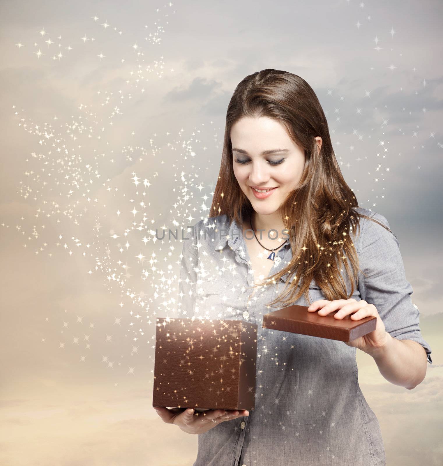 Happy Young Woman Opening a Gift Box