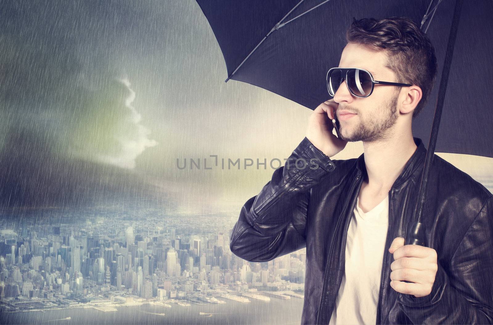 Man talking on his cellphone in the rain by melpomene