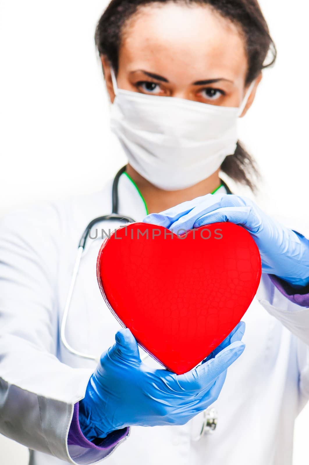 Doctor holding red heart symbol on white background