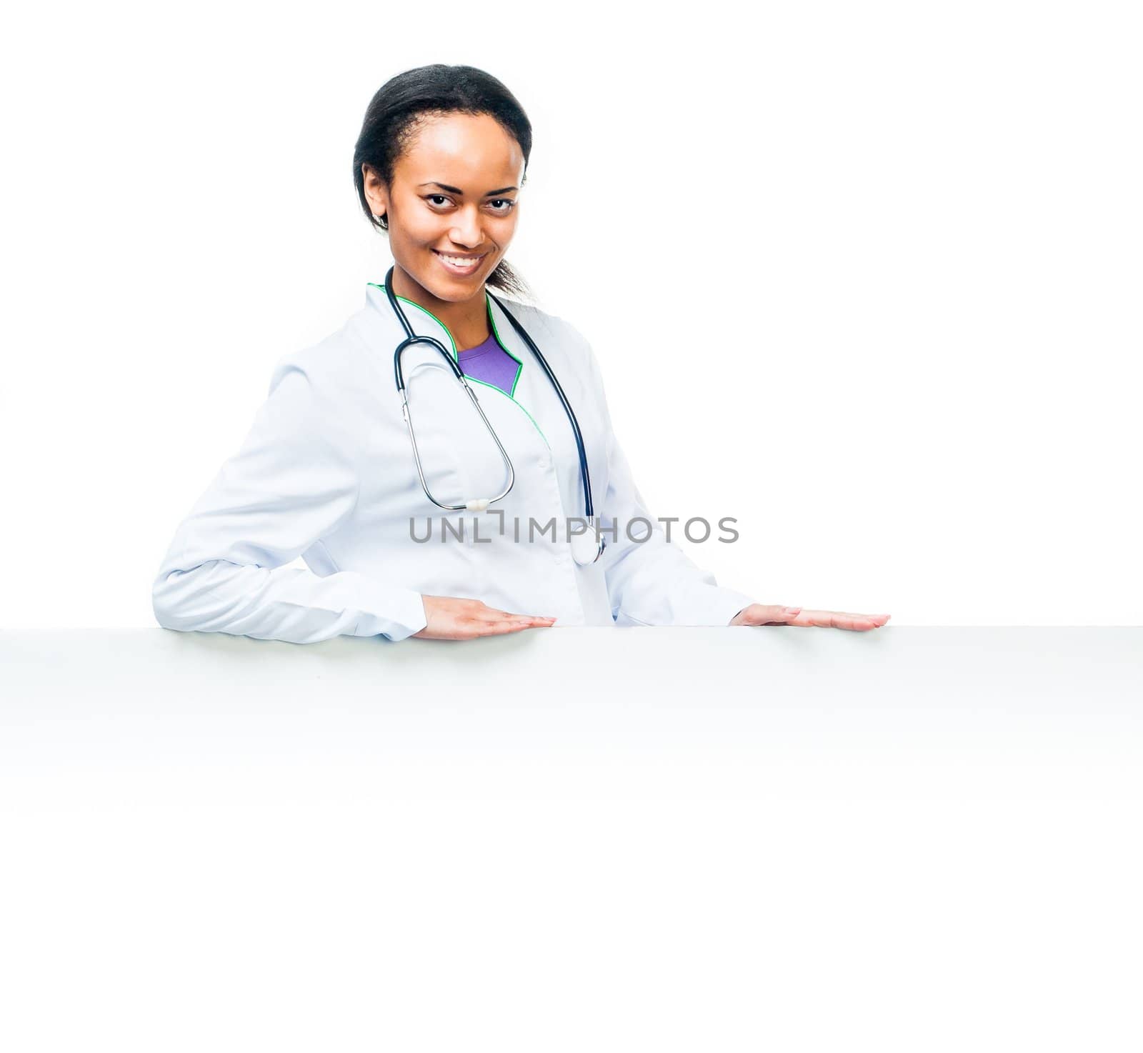 Smiling attractive female doctor with board on a white background