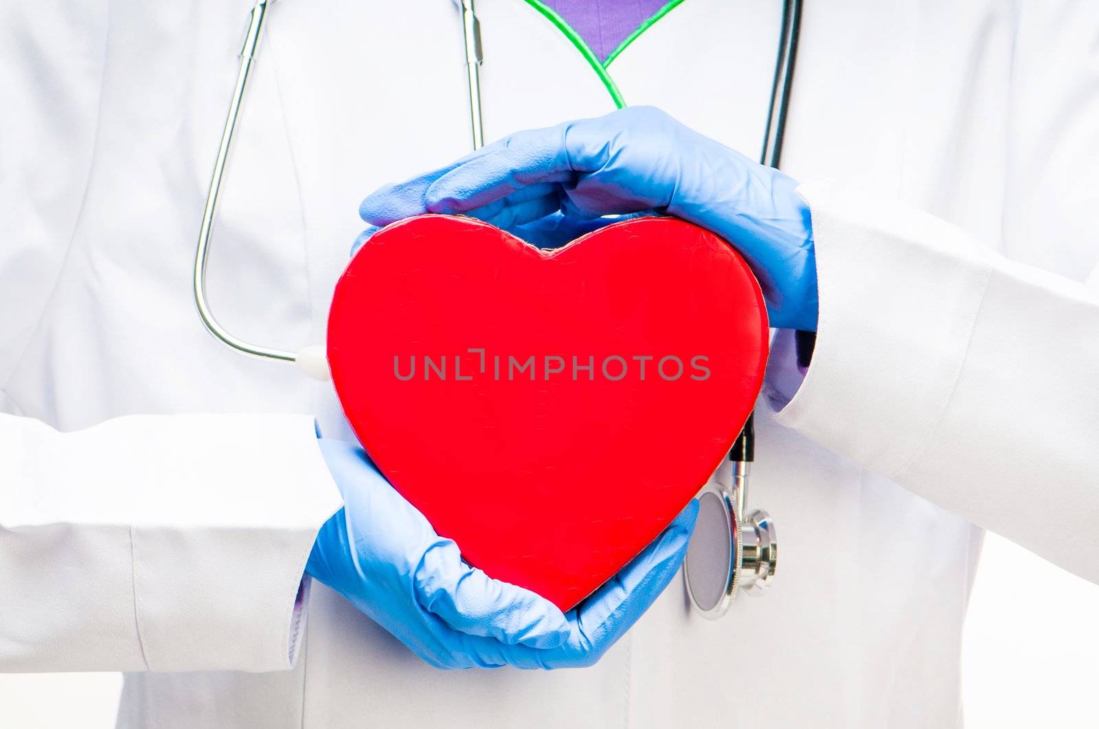 medical doctor holding red heart symbol close up