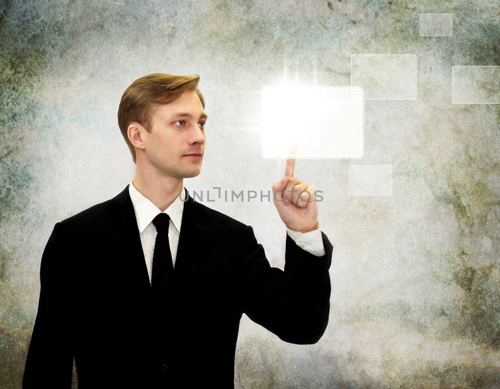 Young business man pressing a button on a touch screen