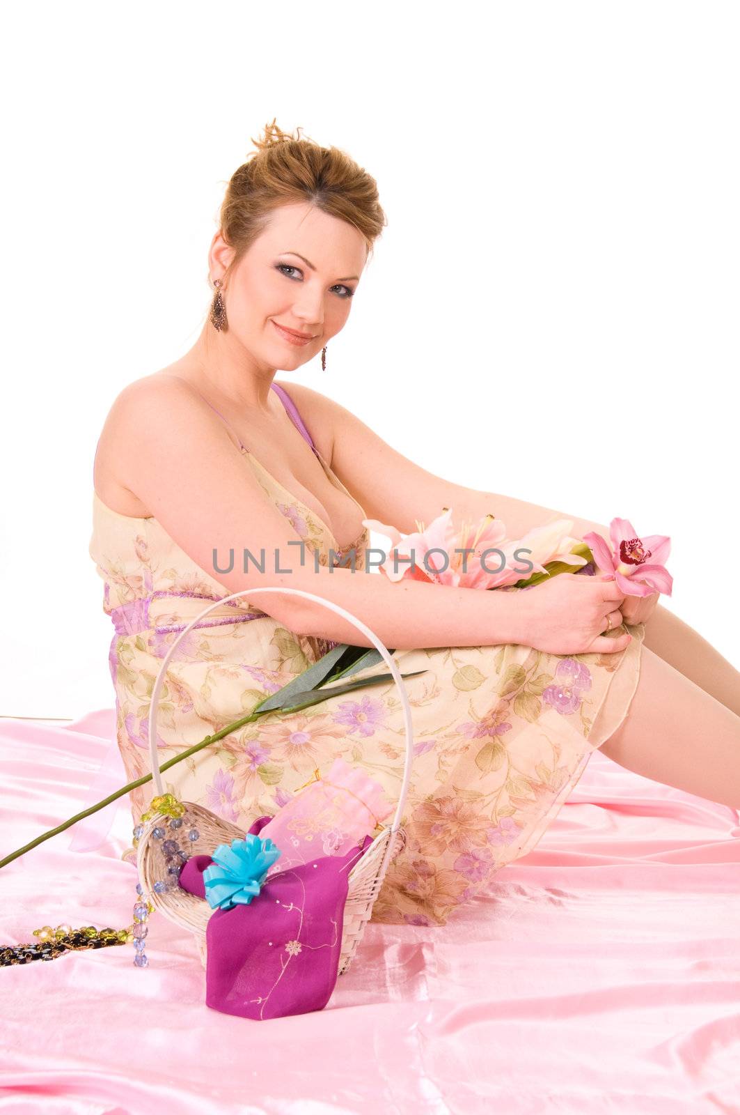 Beautiful woman with nice make-up, flowers and accessories on pink backgroumd