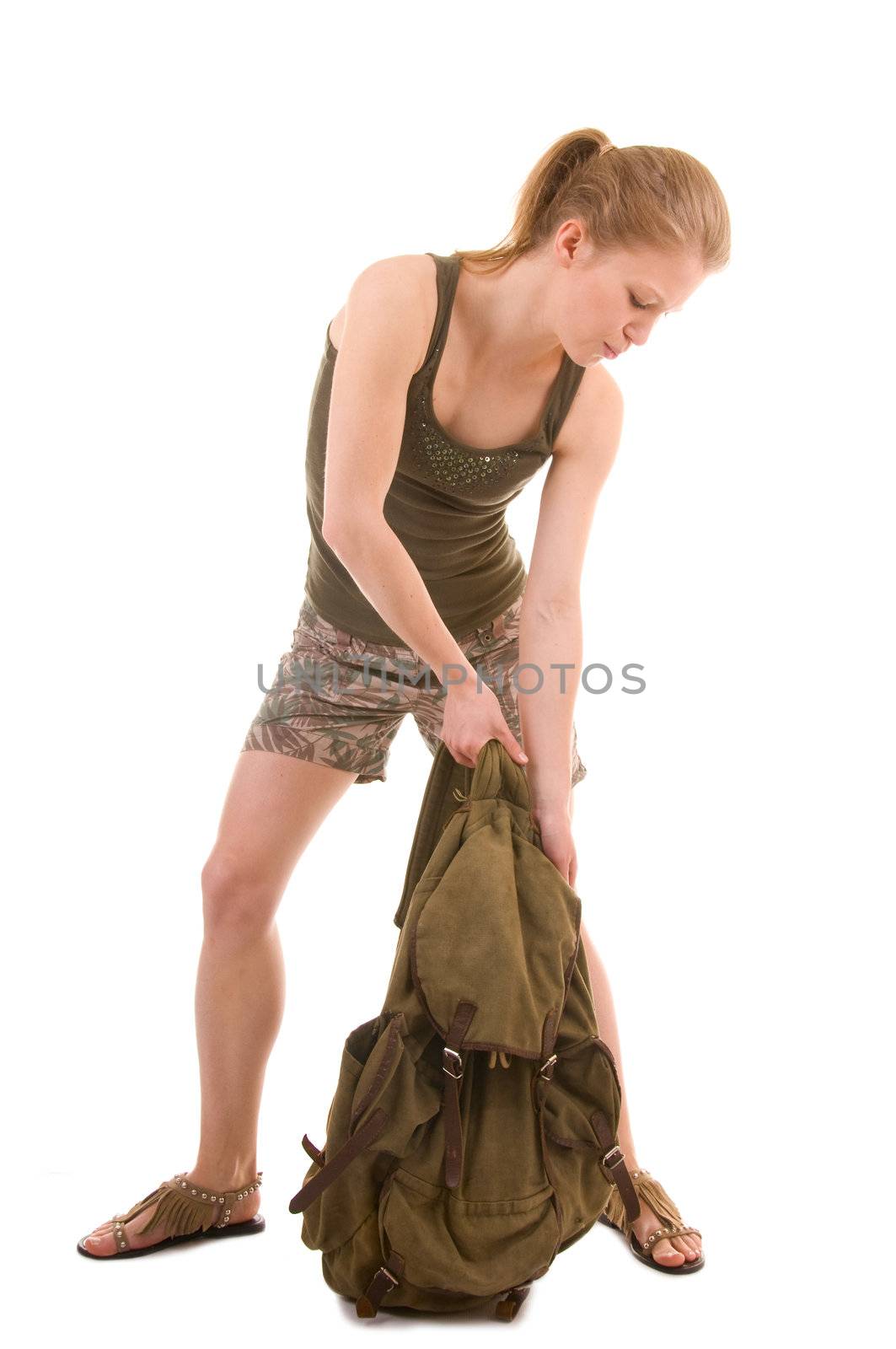 young woman with heavy vintage back pack on white background