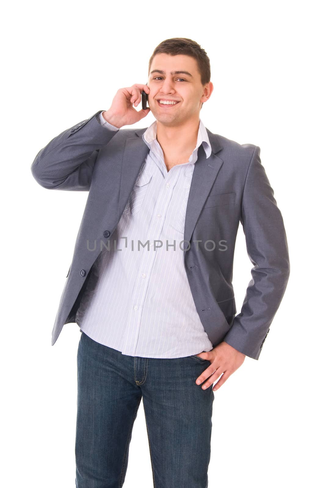 Young casual man in jeans and jacket with phone isolated on white background