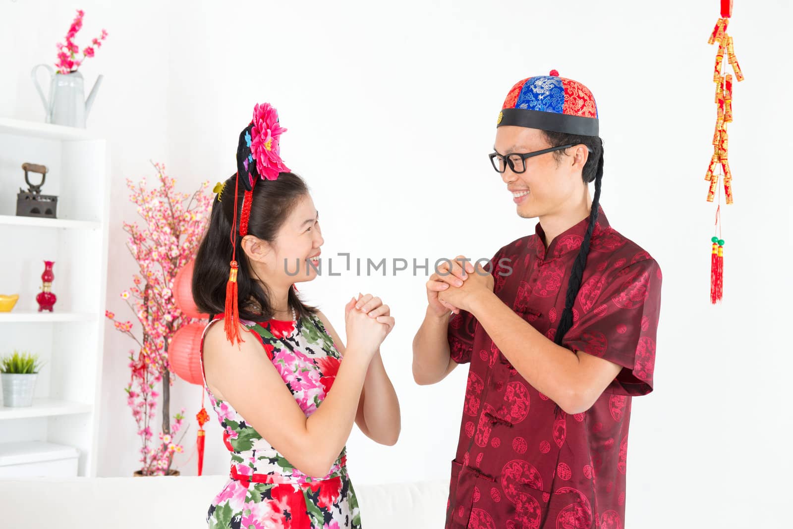 Happy Chinese New Year. Asian people greeting during Chinese New Day, indoor home.