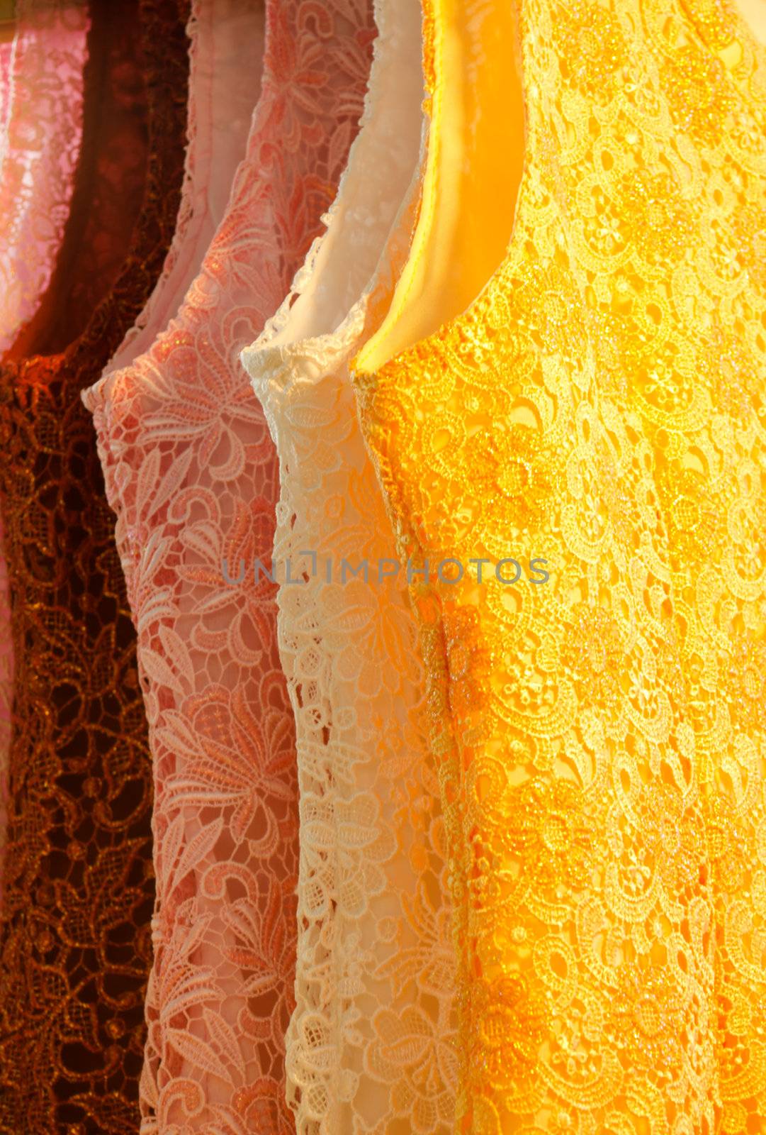 multicolored new lace dress hanging in row on sale
