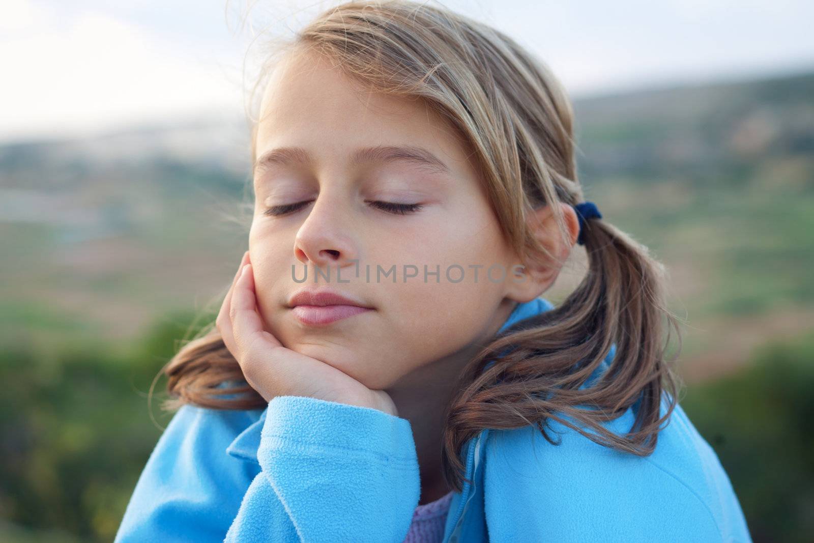 Smiling young girl with closed eyes