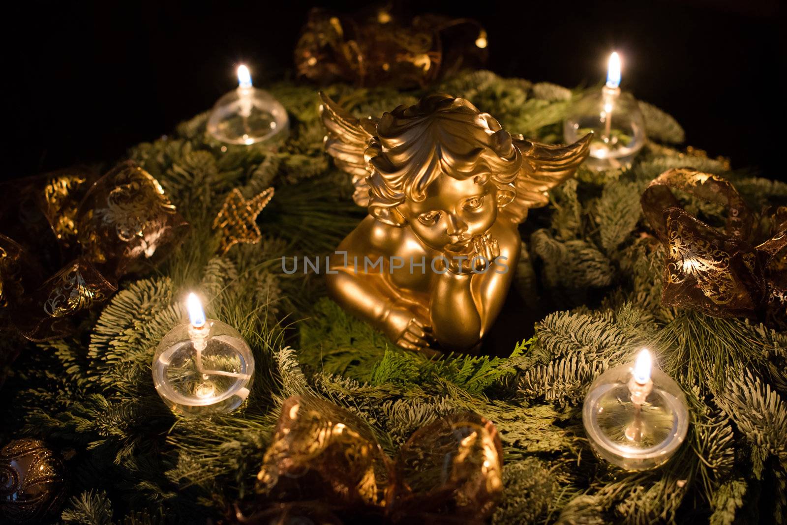Beautiful advent wreath with golden angel on dark background
