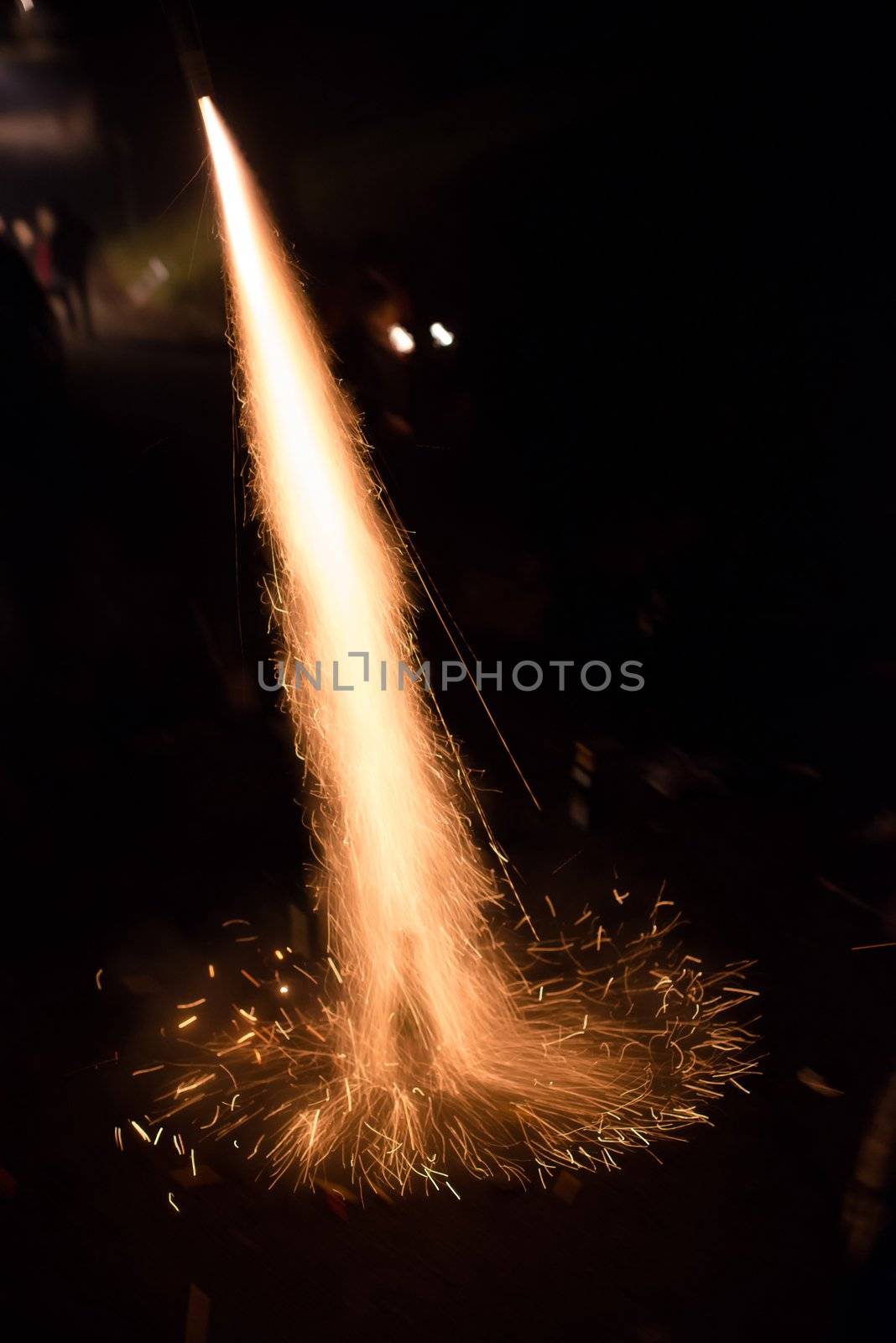 Fireworks rocket being launched out of a champagne bottle on its way into the sky