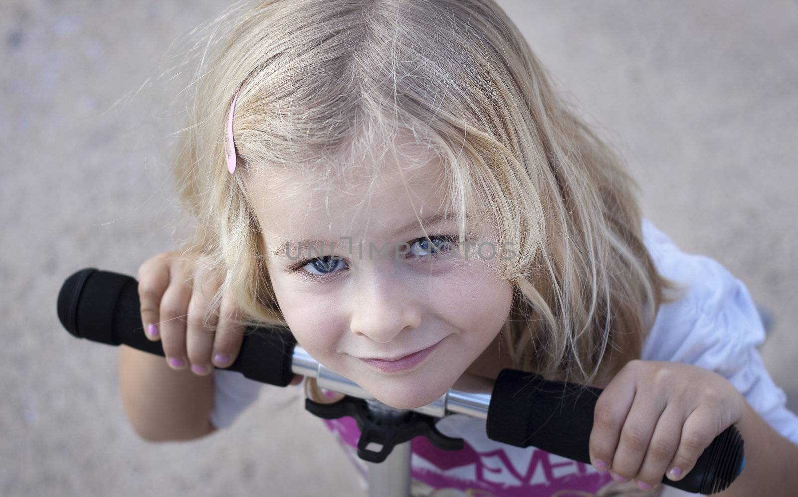 Closeup of girl leaning on handlebar of scooter
